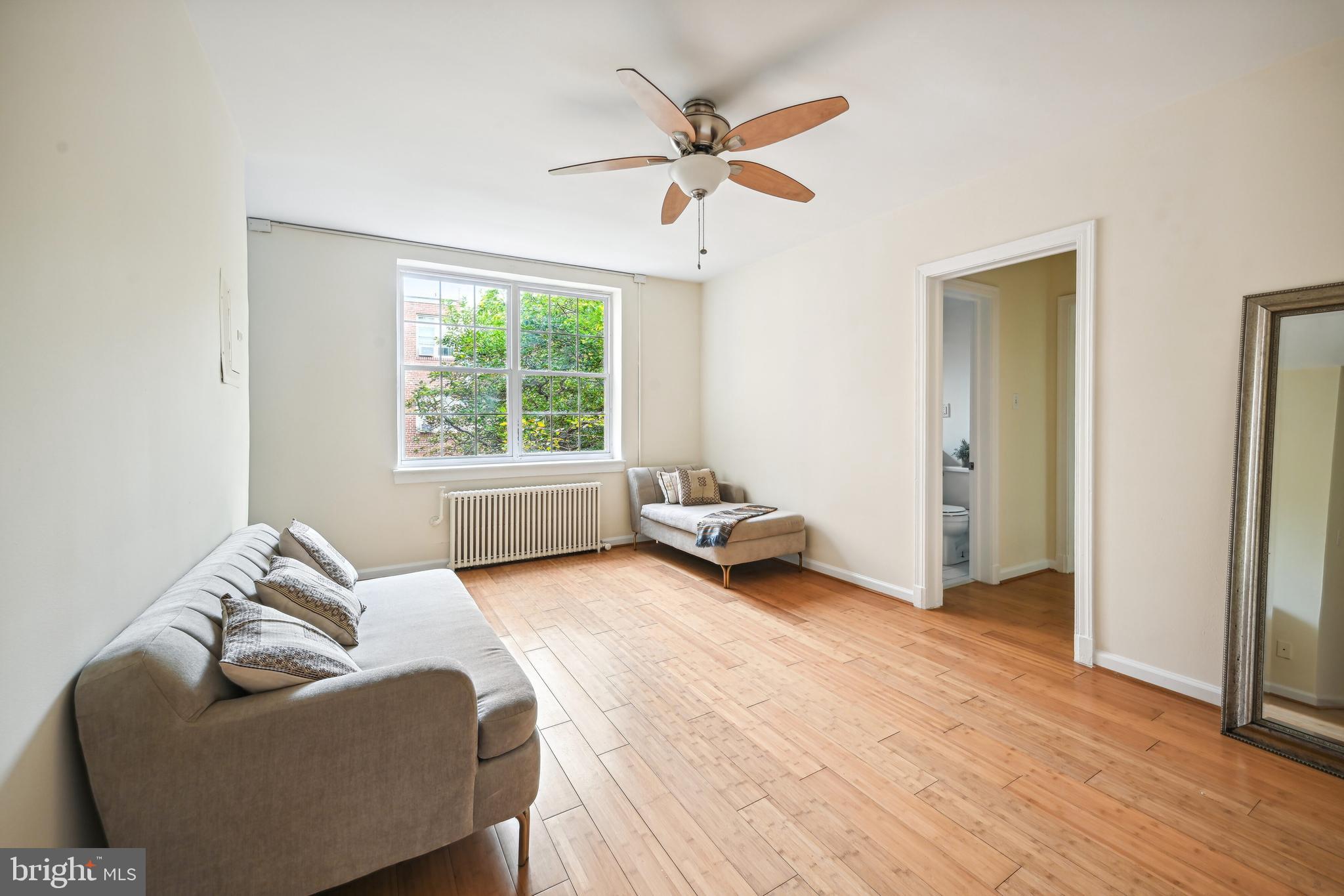 939 Longfellow Street Northwest, Unit 205 Washington, DC 20011 - Photo 7 of 16 a living room with furniture and a window