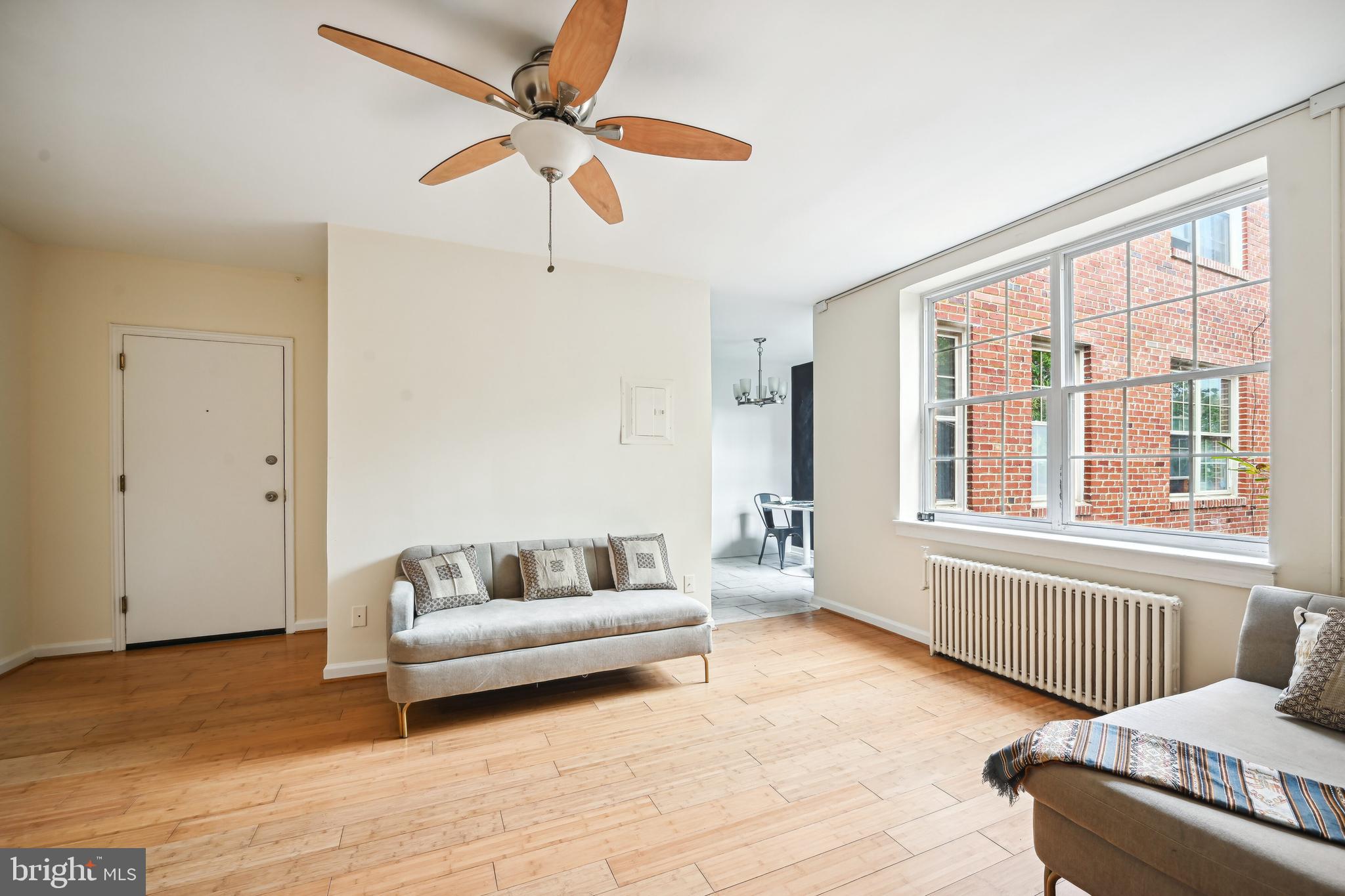 939 Longfellow Street Northwest, Unit 205 Washington, DC 20011 - Photo 9 of 16 a living room with furniture and a window