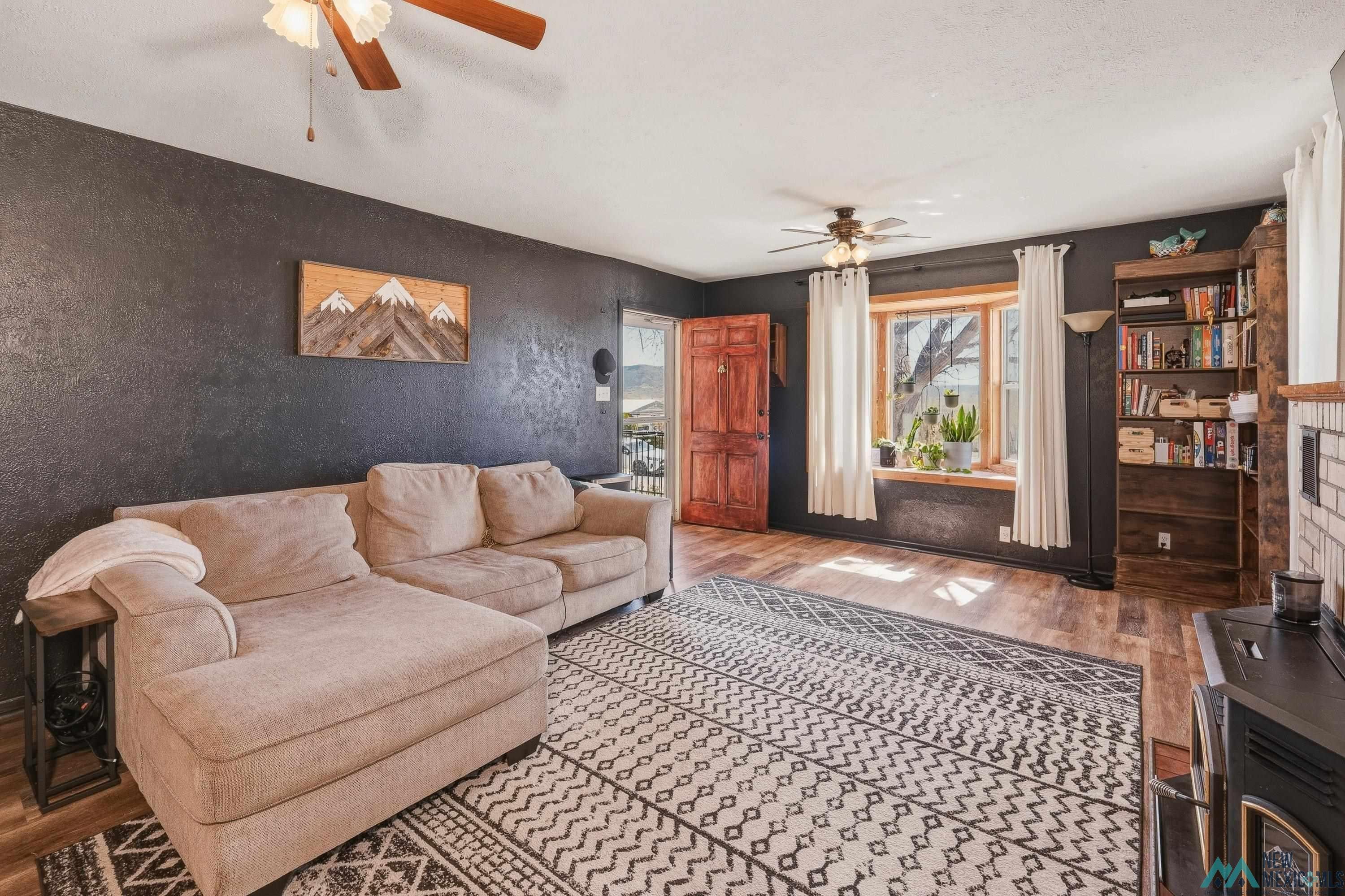 1432 South 5th Street Raton, NM 87740 - Photo 6 of 32 Living room featuring wood finished floors and a ceiling fan