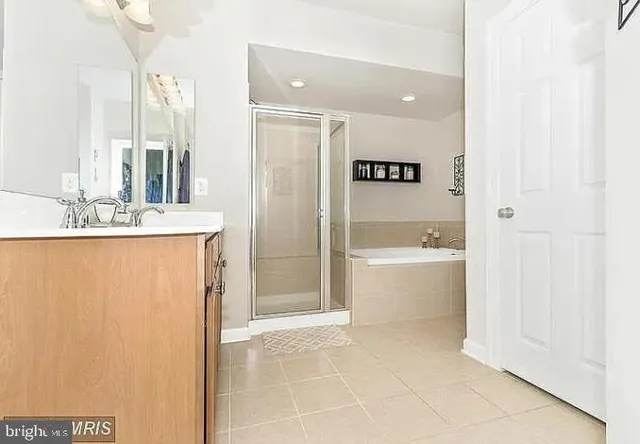 a bathroom with a bathtub sink and mirror