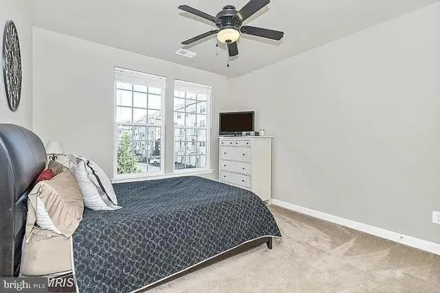 a bedroom with a bed and window