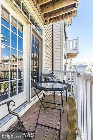 a view of a patio with table and chairs and wooden floor