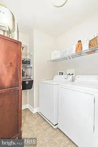 a utility room with cabinets washer and dryer