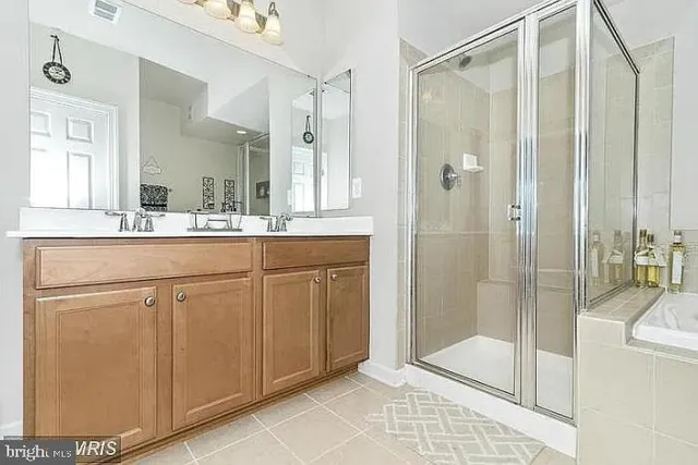 a bathroom with a shower sink and mirror
