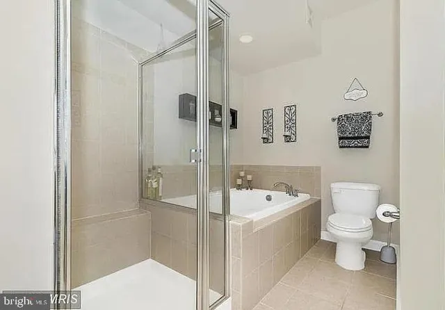 a bathroom with a toilet a sink and bathtub