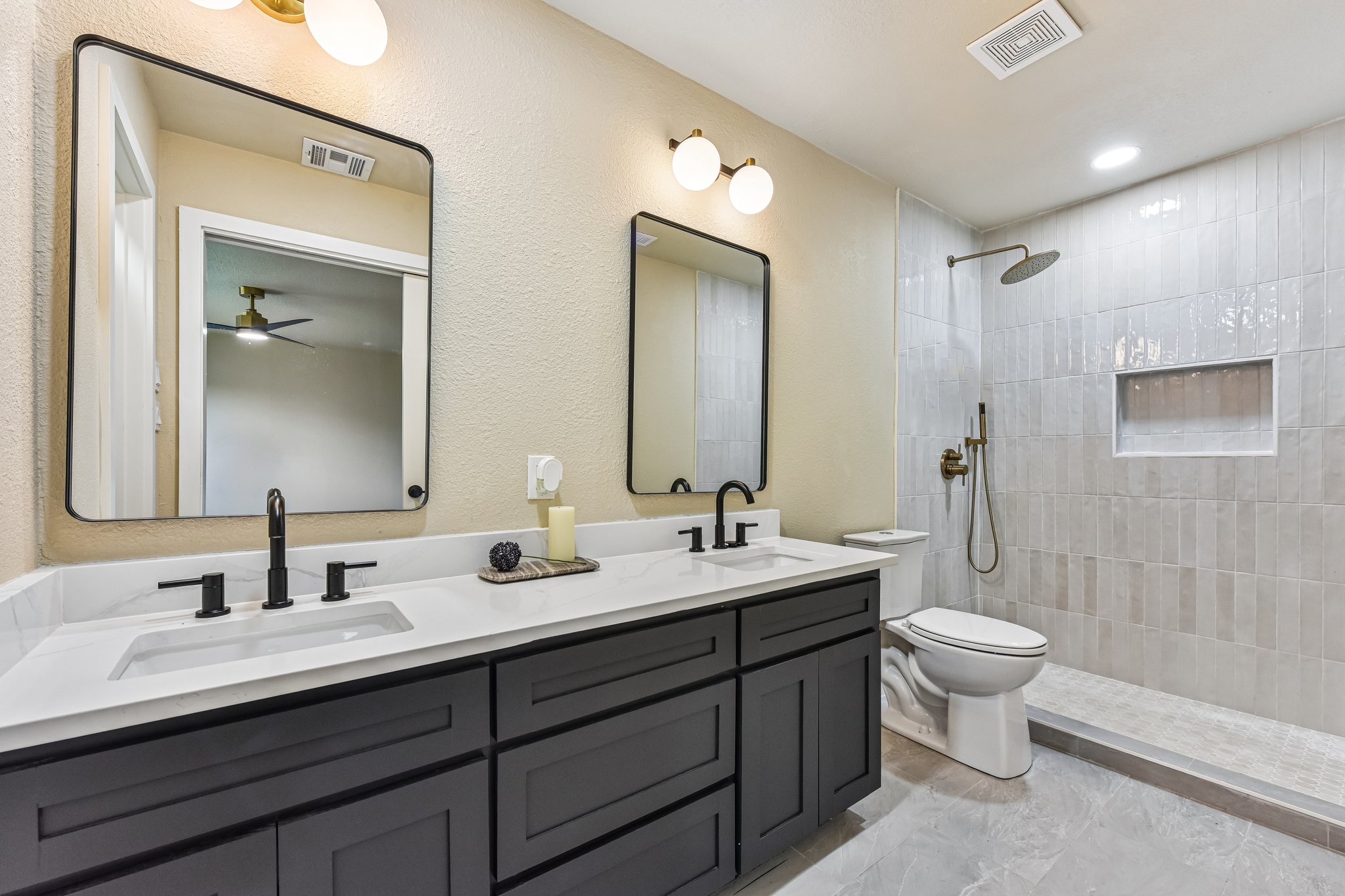 7523 Glenhill Road Austin, TX 78752 - Photo 20 of 38 Double vanities and an open-concept shower create a refined personal retreat.