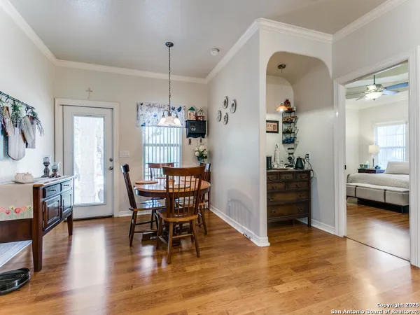 a view of a dining room with furniture and wooden floor