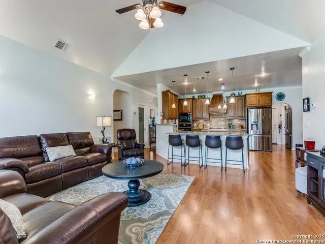 a living room with furniture and a chandelier