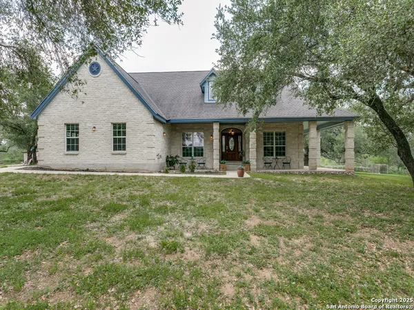 a front view of house with yard and green space
