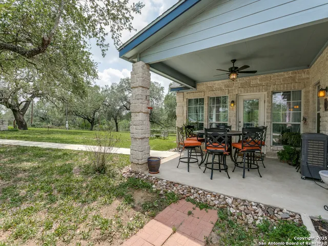 a building outdoor space with patio furniture and garden