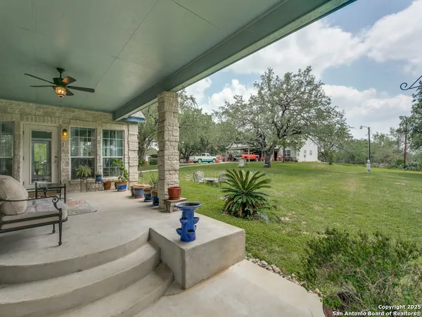 a view of a house with a yard porch and sitting area