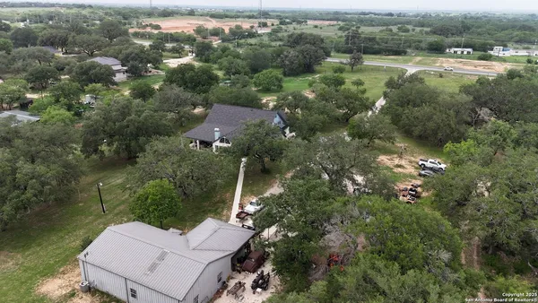 an aerial view of a house with a yard