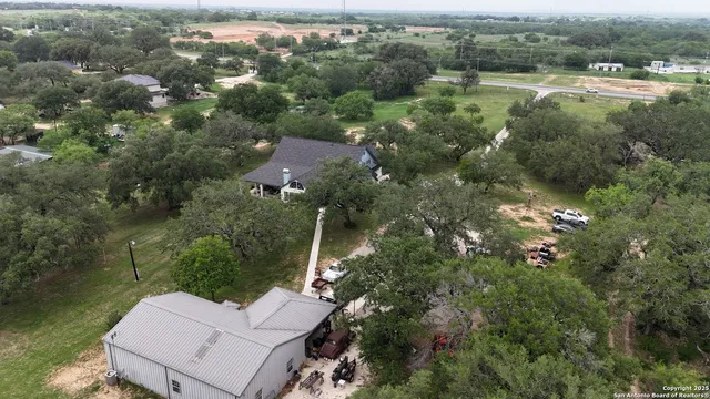 an aerial view of a house with a yard