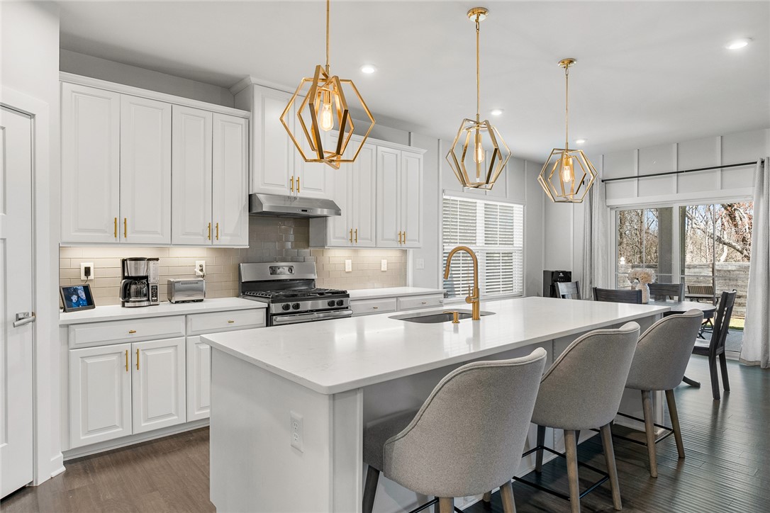 115 Bronson Ridge Anderson, SC 29621 - Photo 12 of 40 Gleaming stone countertops and a spacious central island anchor this open-concept kitchen.