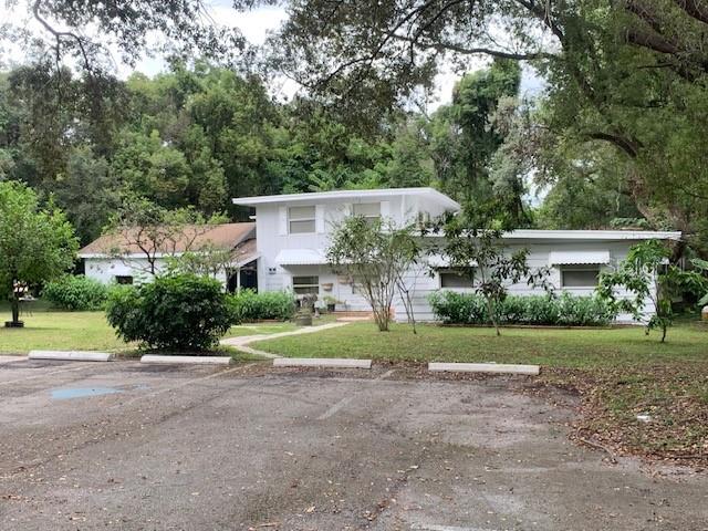 4839 Clarcona Ocoee Road Orlando, FL 32810 - Photo 1 of 1 a view of a house with a yard and large trees