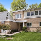 a front view of a house with a yard garage and outdoor seating