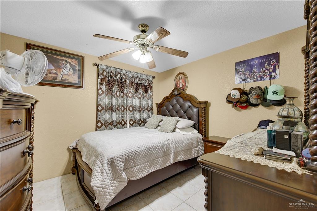 309 Domingo Navarez Street Rio Grande City, TX 78582 - Photo 8 of 14 Bedroom with a ceiling fan and light tile patterned floors