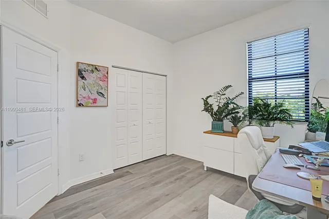 a living room with furniture and flowers