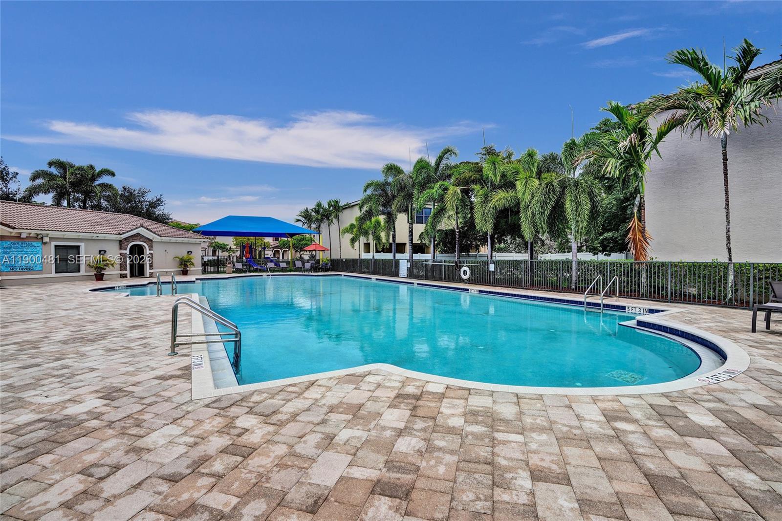 650 Northeast 193rd Terrace Miami, FL 33179 - Photo 27 of 32 a view of pool with outdoor seating and house in the background
