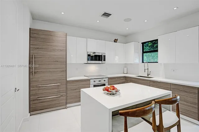 a kitchen with a sink cabinets and wooden floor