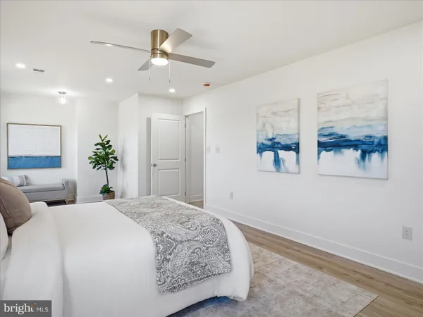 a bedroom with a large bed and a chandelier