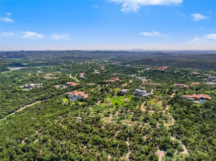 an aerial view of residential houses with city view