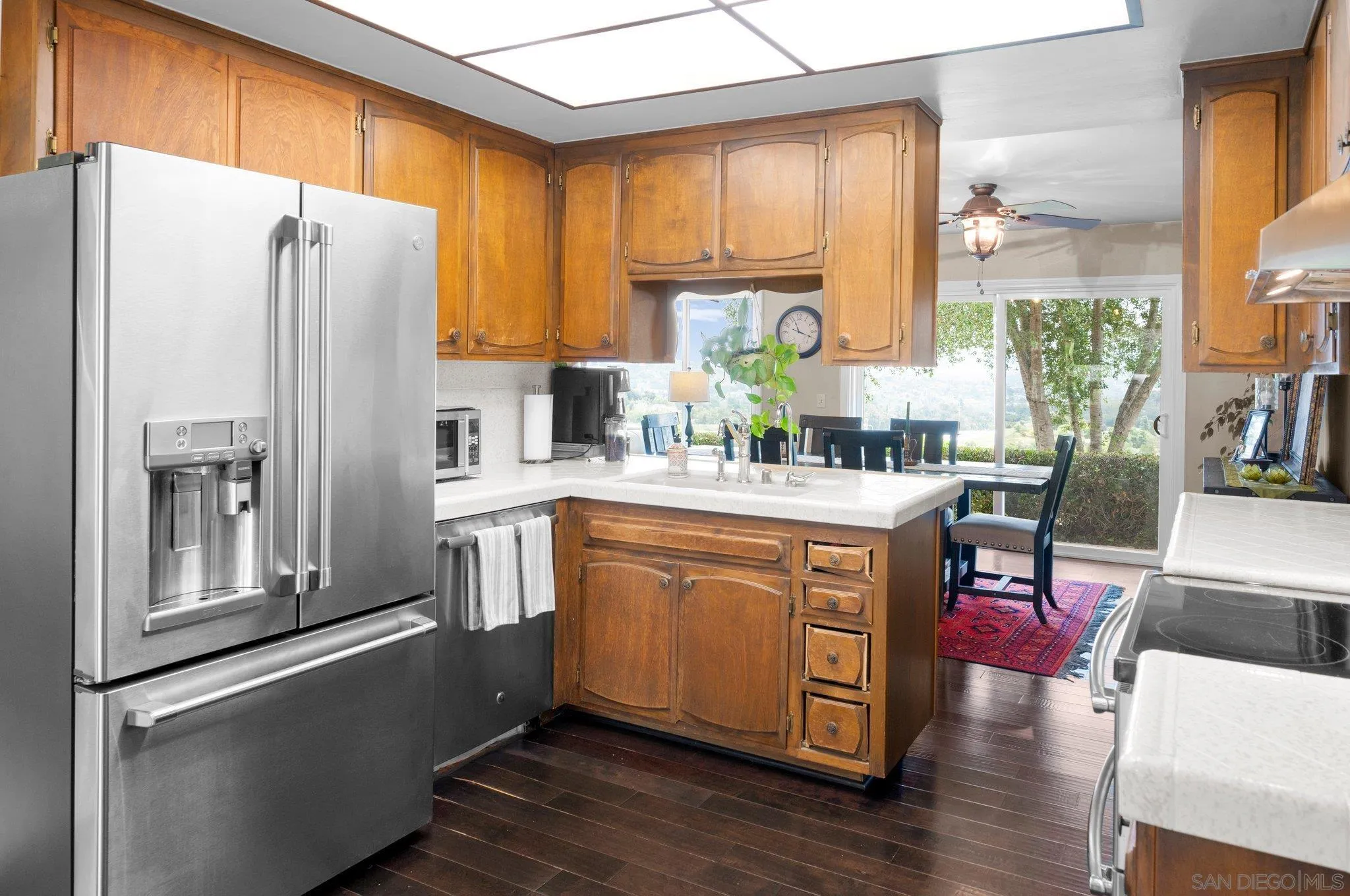 2189 Rockhoff Road Escondido, CA 92026 - Photo 26 of 60 a kitchen with stainless steel appliances granite countertop a refrigerator a stove and a wooden cabinets
