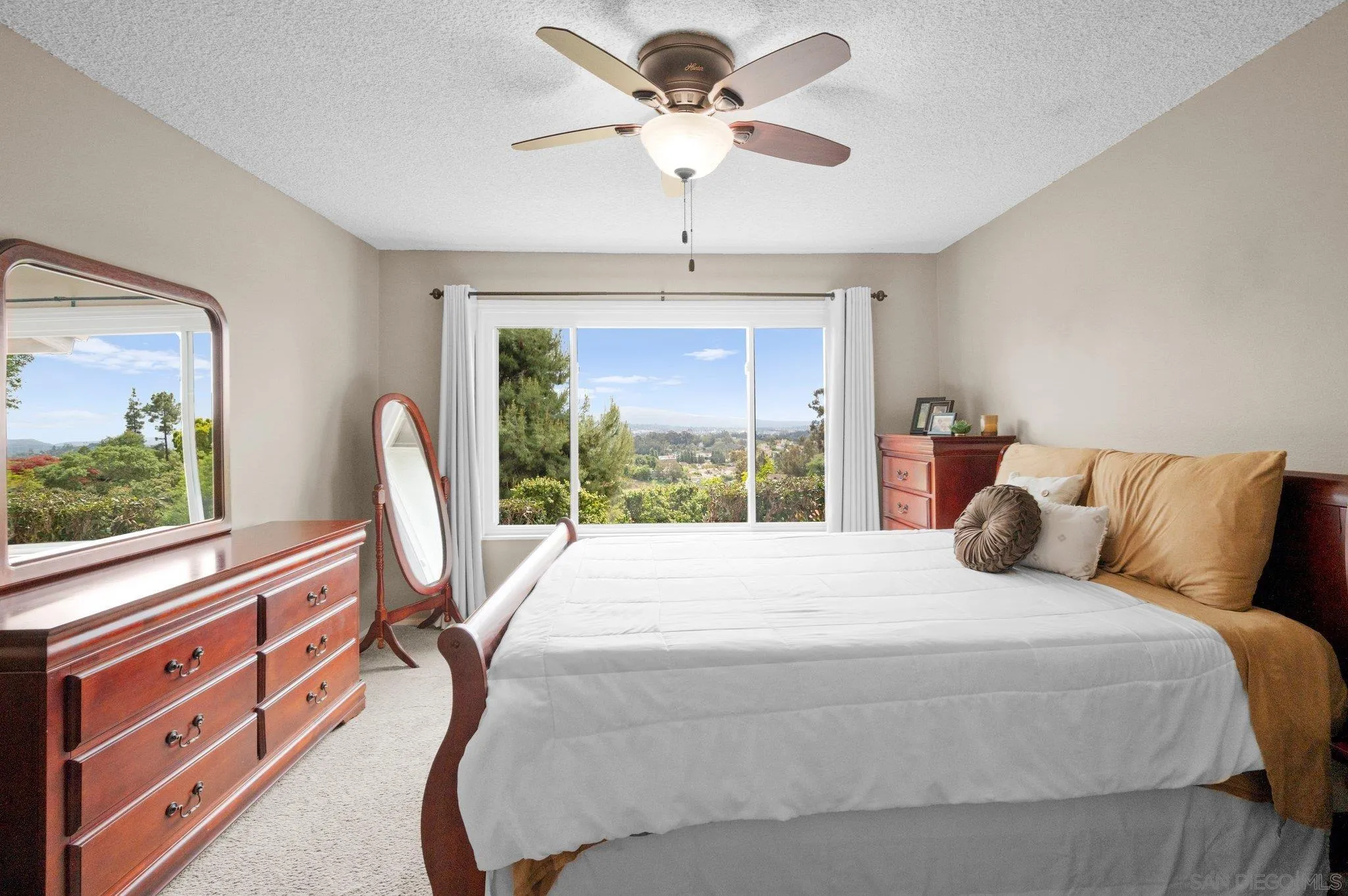 2189 Rockhoff Road Escondido, CA 92026 - Photo 32 of 60 a bedroom with a large bed and a chandelier