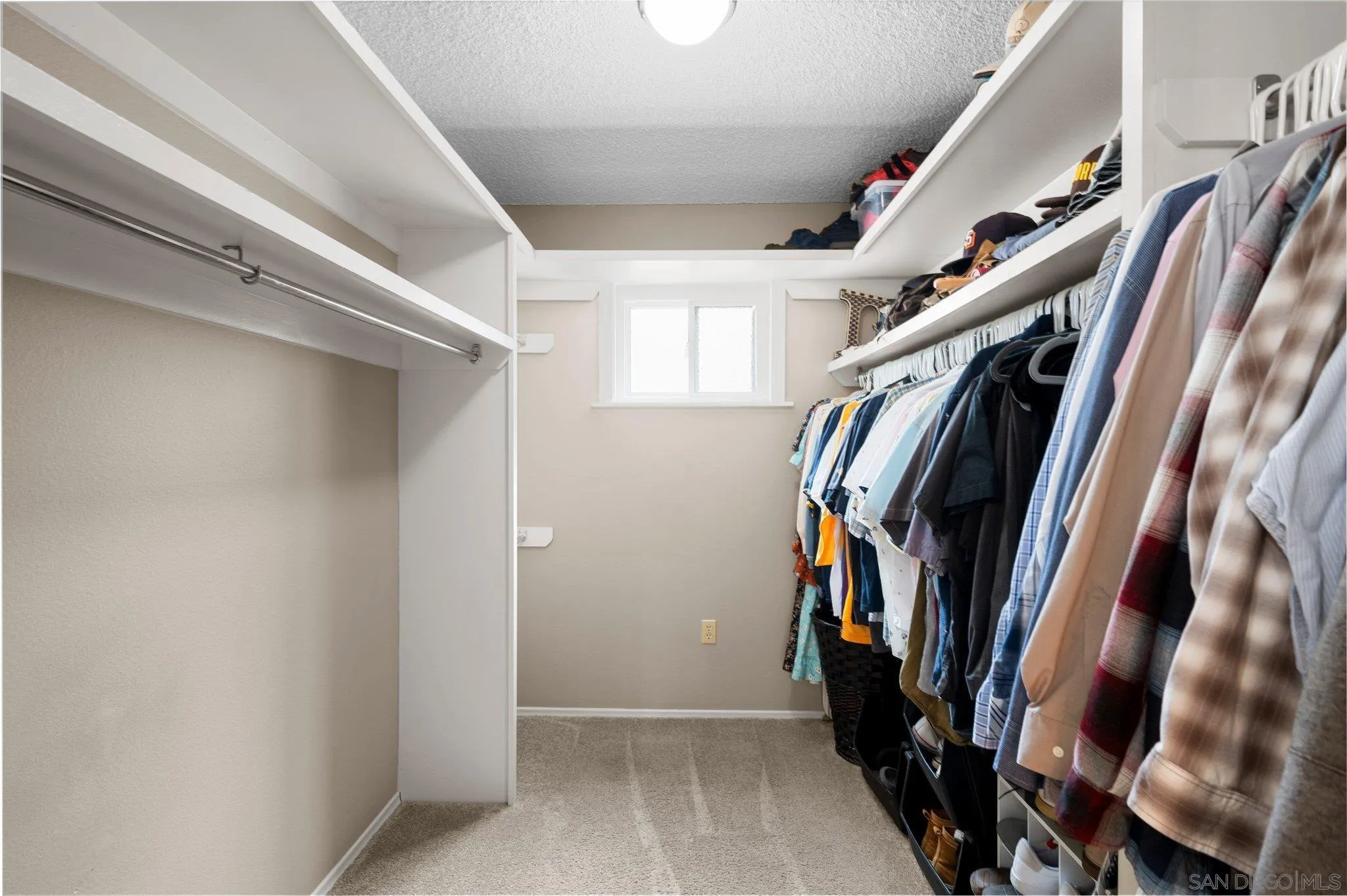 2189 Rockhoff Road Escondido, CA 92026 - Photo 36 of 60 a view of walk in closet with clothes and shoes