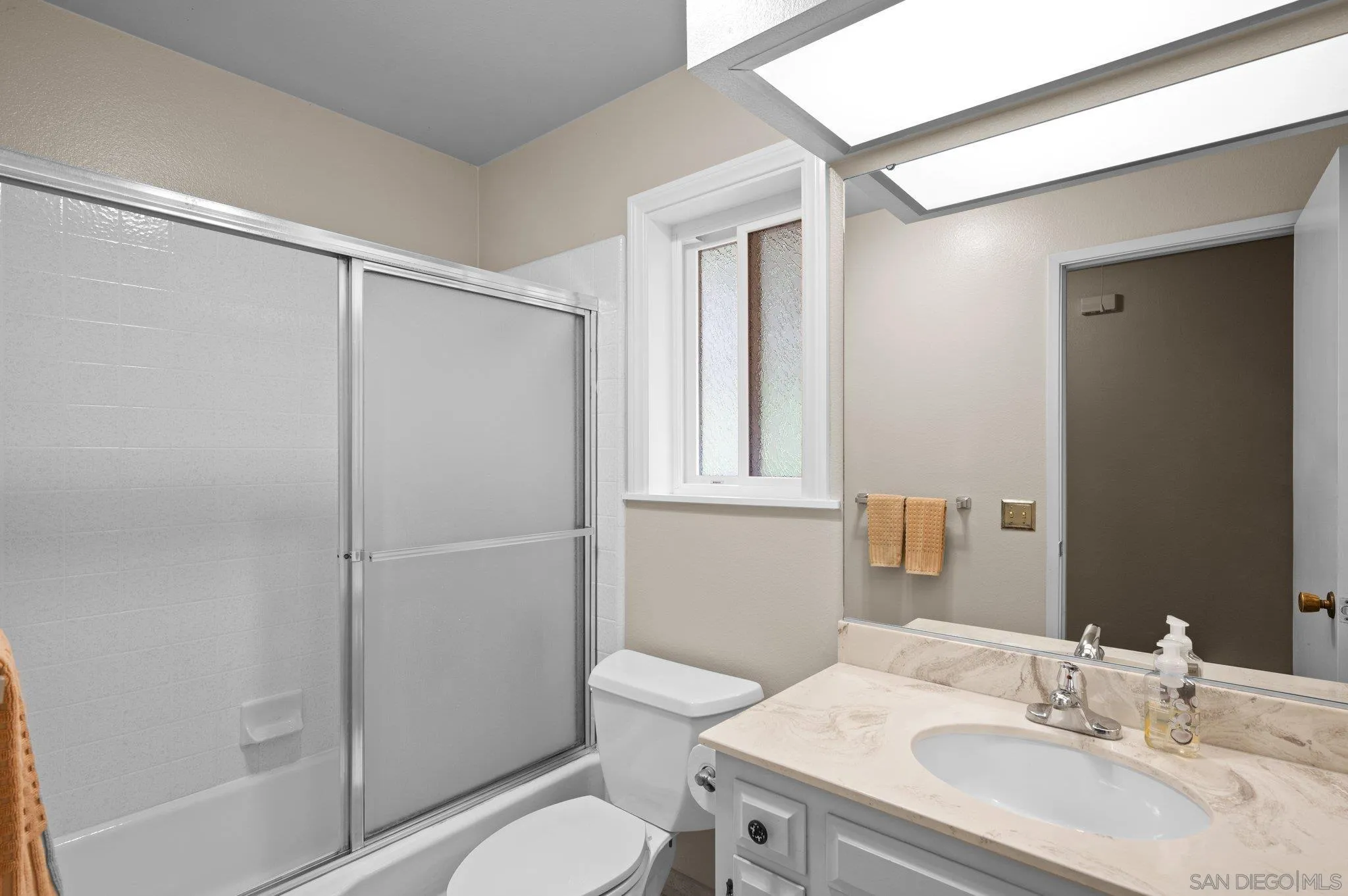 2189 Rockhoff Road Escondido, CA 92026 - Photo 39 of 60 a bathroom with a granite countertop sink toilet and shower