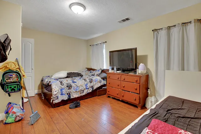 a bedroom with furniture and a flat screen tv