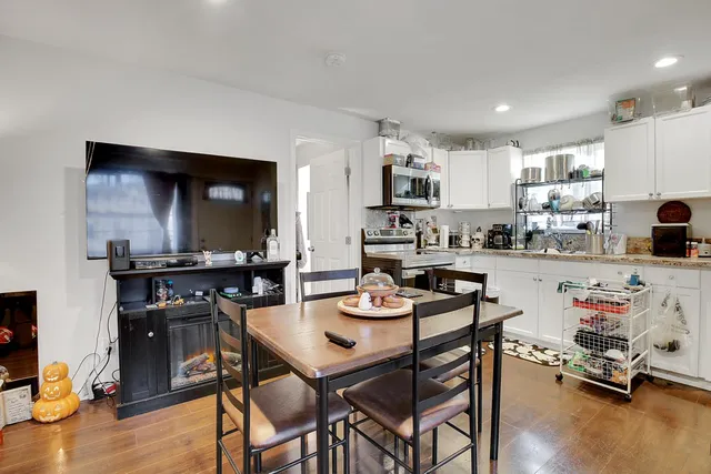 a kitchen with a dining table chairs and a stove