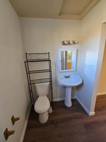 a bathroom with a toilet sink and window