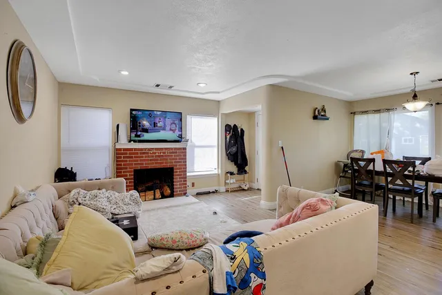 a living room with furniture and a fireplace
