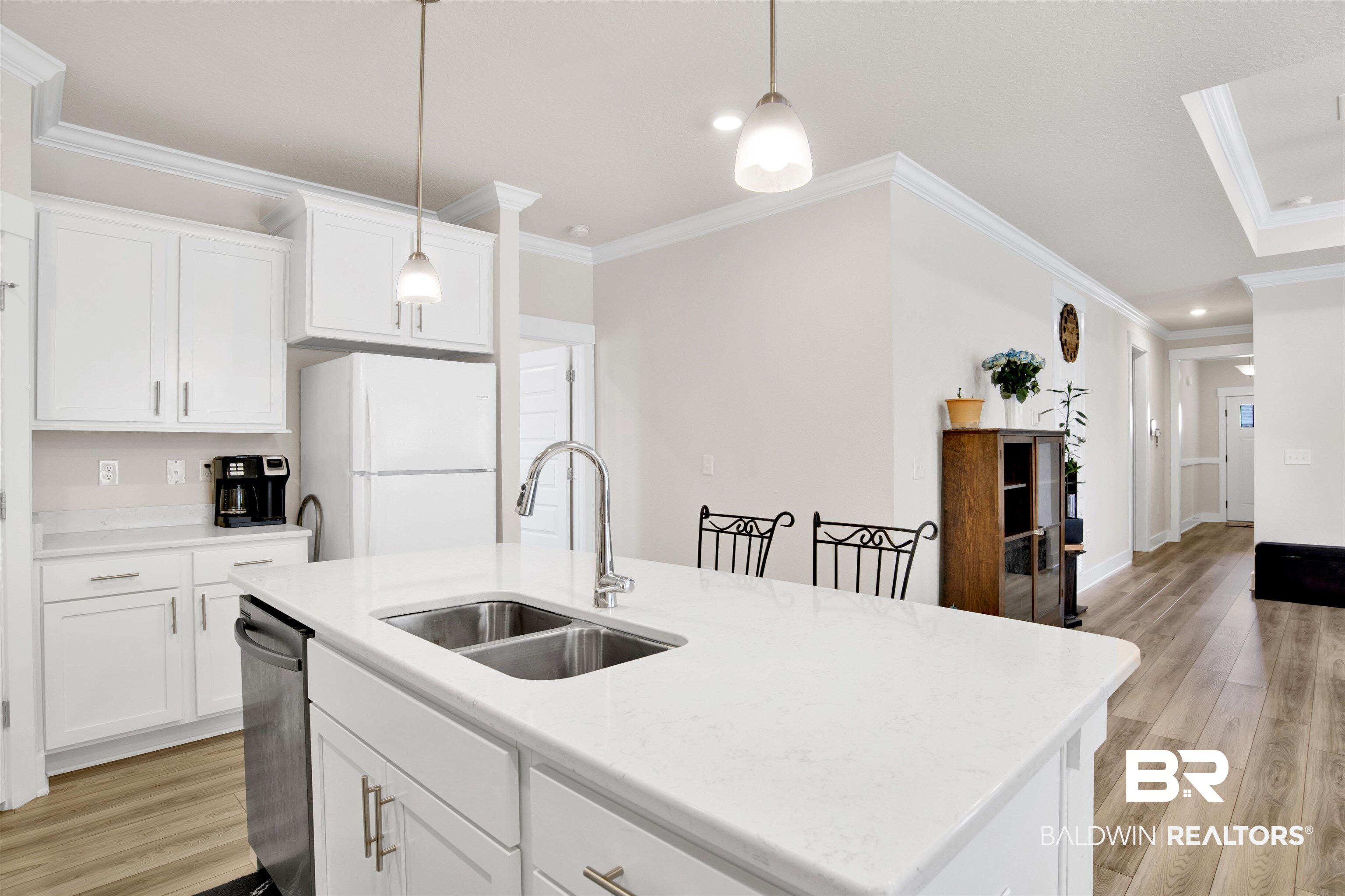 1174 Pheasant Circle Foley, AL 36535 - Photo 14 of 29 Kitchen with white cabinets, light wood finished floors, freestanding refrigerator, crown molding, and an island with sink