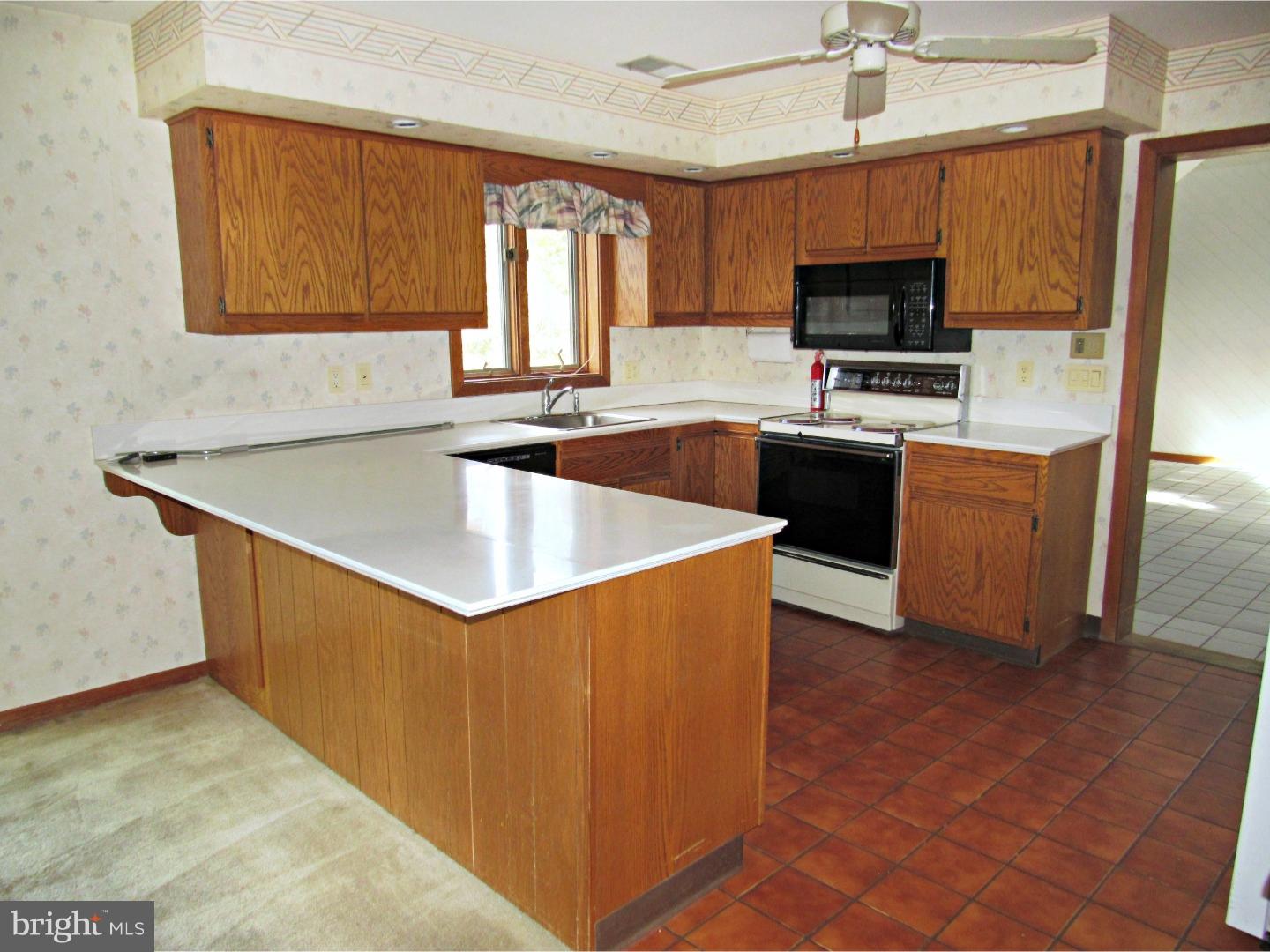 317 Clump Road Green Lane, PA 18054 - Photo 13 of 23 a kitchen with stainless steel appliances a stove a sink a microwave a counter top space and cabinets