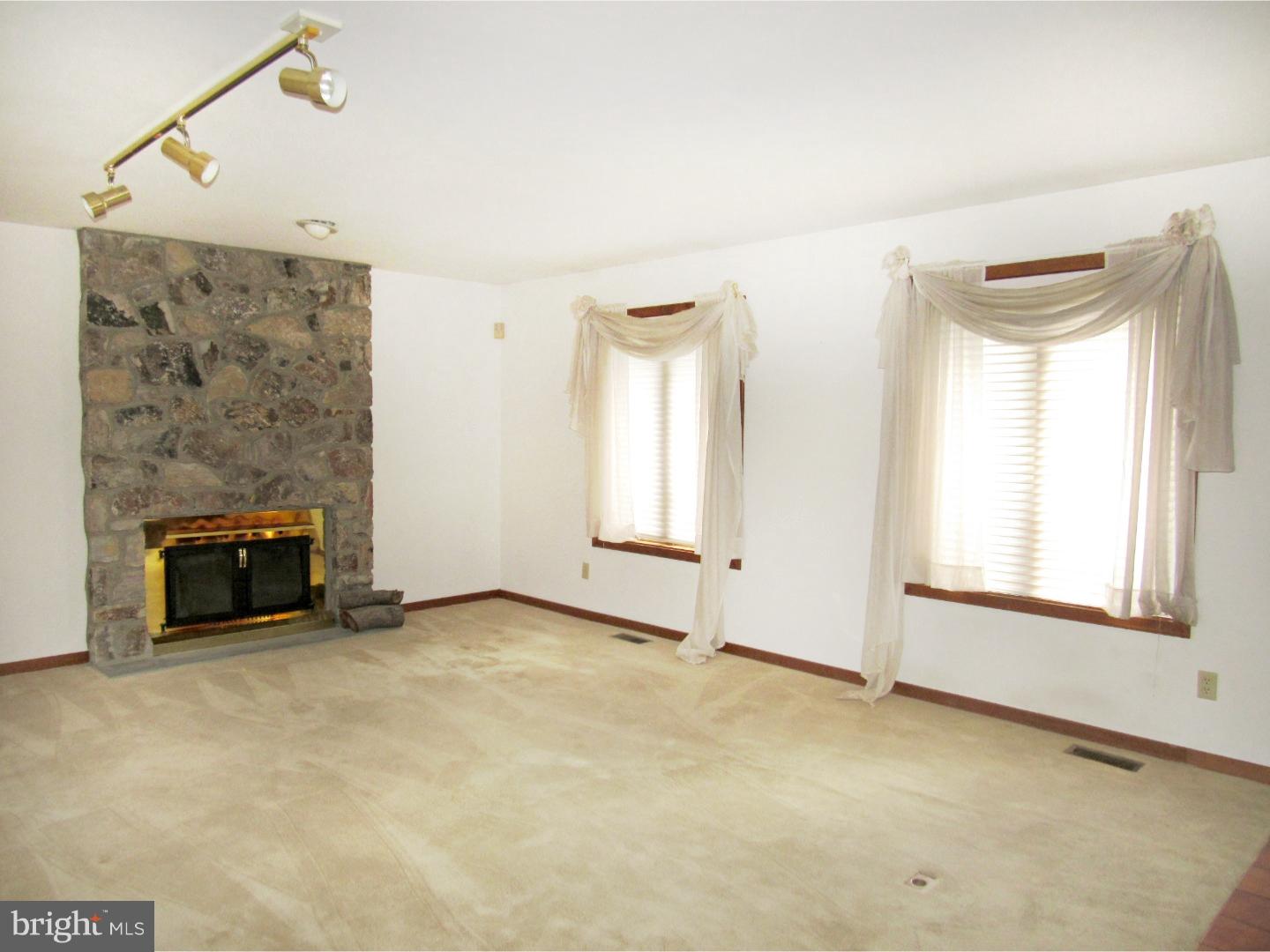317 Clump Road Green Lane, PA 18054 - Photo 16 of 23 a view of an empty room with a fireplace and a window