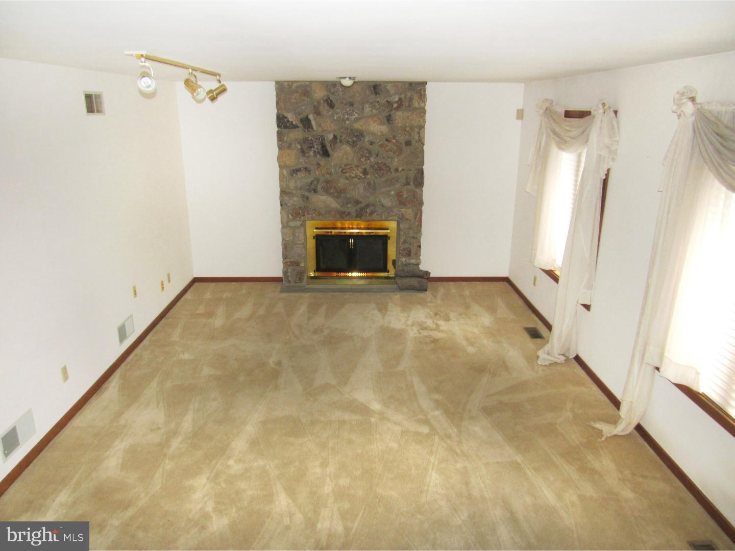 317 Clump Road Green Lane, PA 18054 - Photo 18 of 23 a view of an empty room with a fireplace