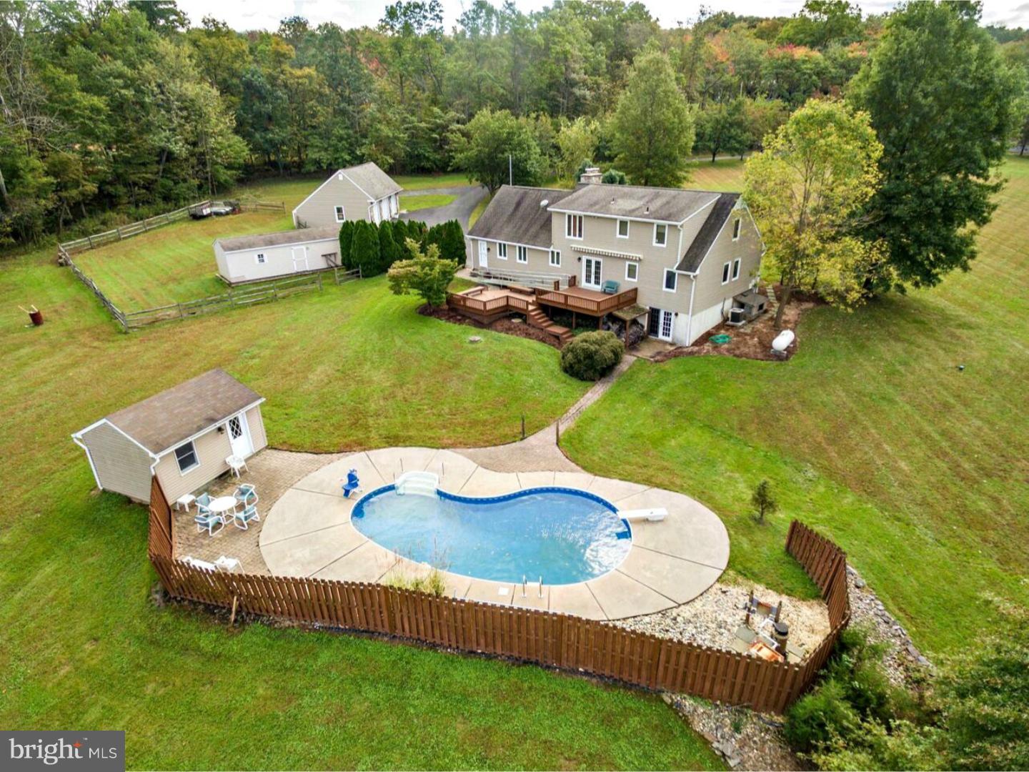 317 Clump Road Green Lane, PA 18054 - Photo 6 of 23 an aerial view of a house with swimming pool garden and trees