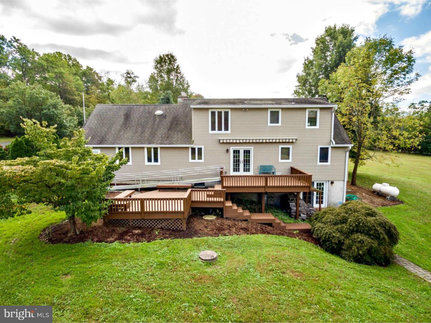 317 Clump Road Green Lane, PA 18054 - Photo 7 of 23 a backyard of a house with table and chairs