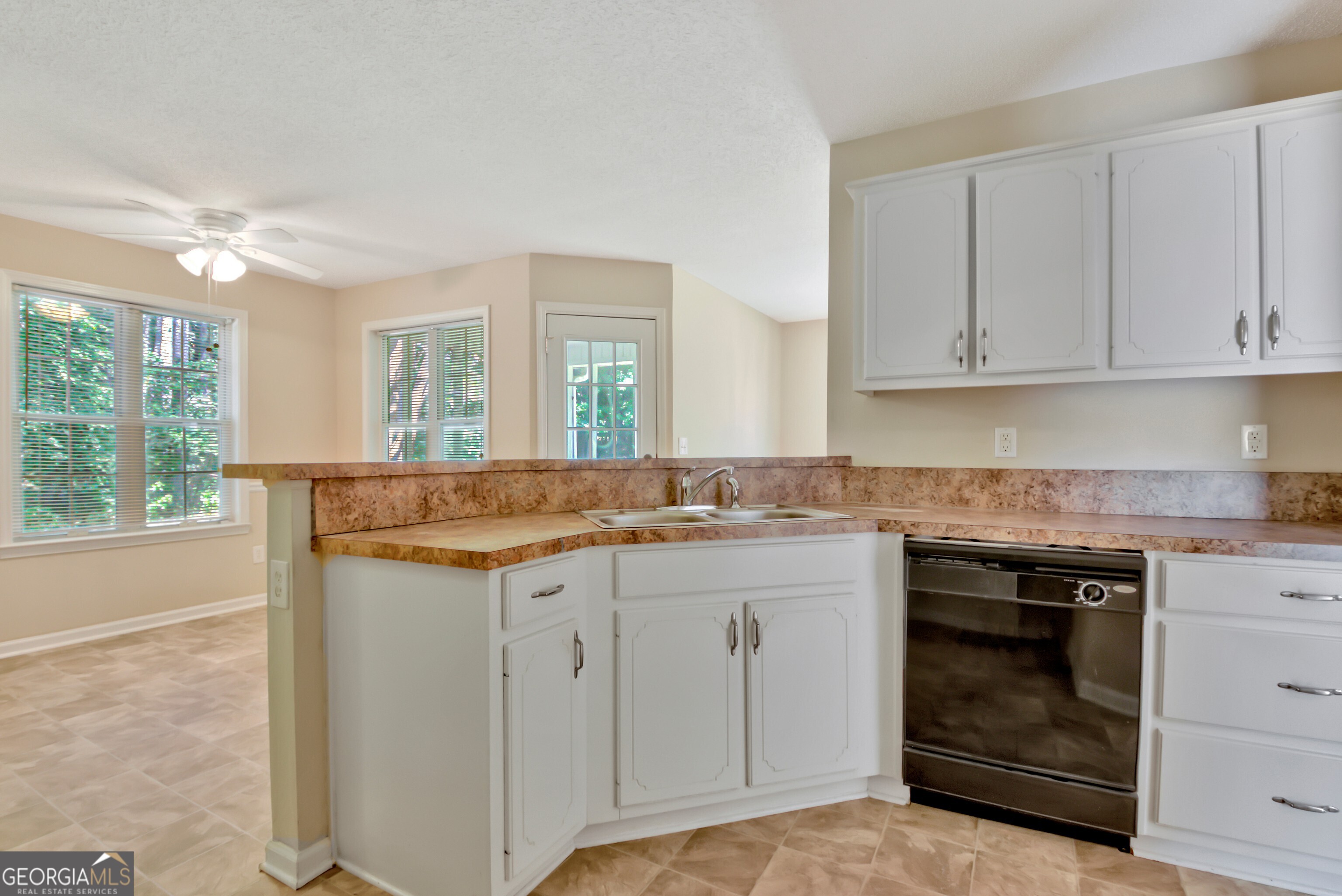 45 Paces Landing Drive Newnan, GA 30263 - Photo 13 of 31 a kitchen with granite countertop a sink and cabinets