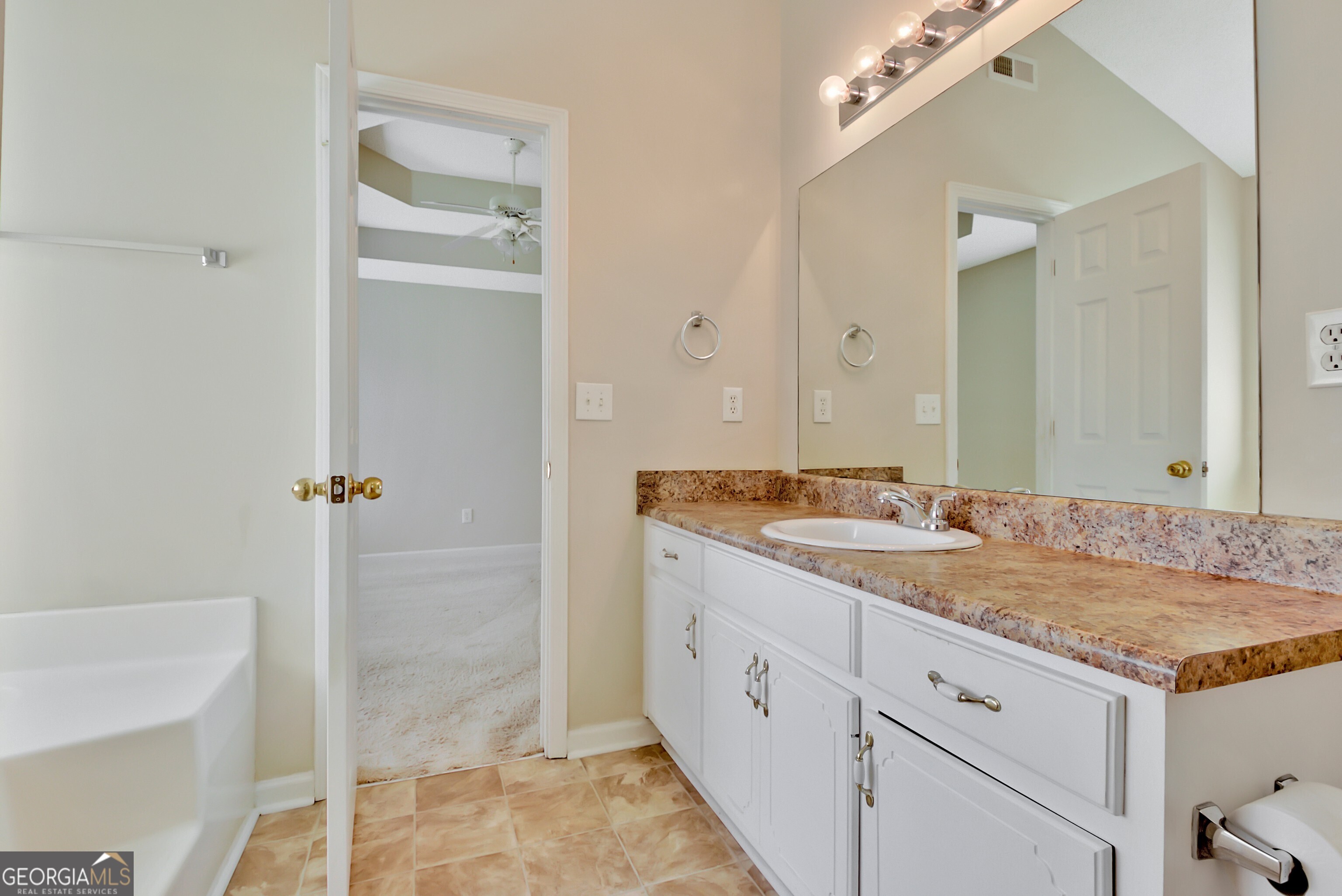 45 Paces Landing Drive Newnan, GA 30263 - Photo 20 of 31 a bathroom with a granite countertop sink and a mirror