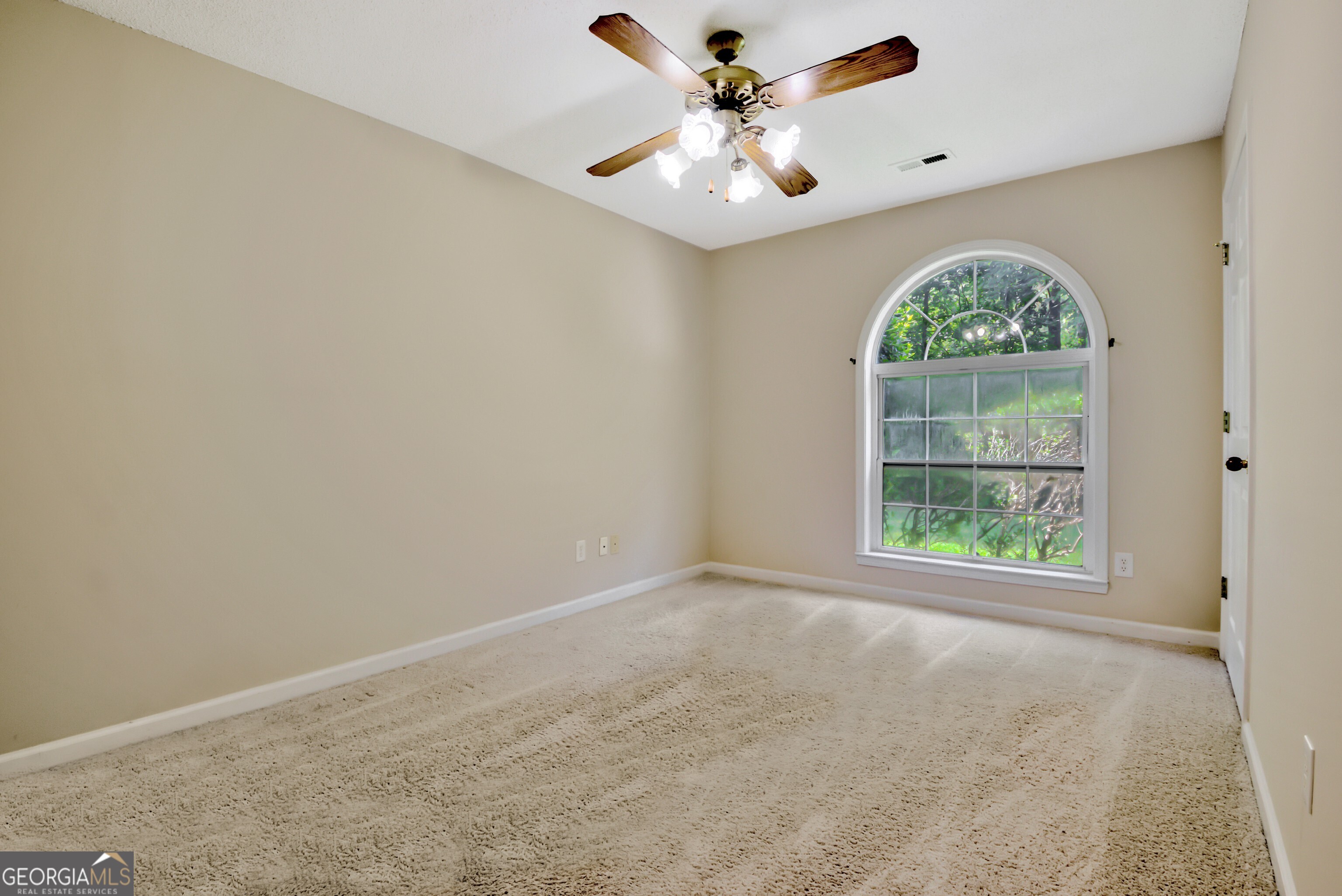 45 Paces Landing Drive Newnan, GA 30263 - Photo 23 of 31 an empty room with a window and a fan
