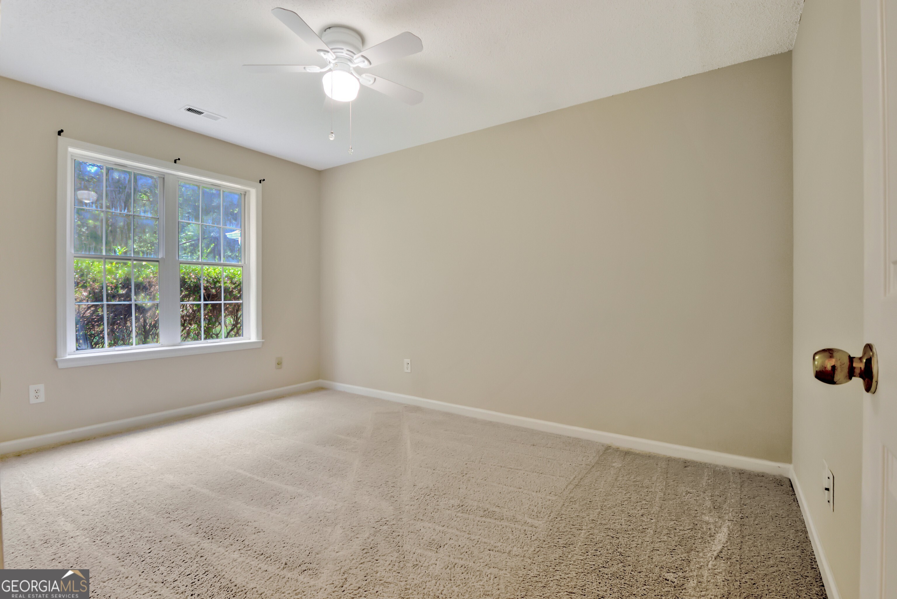 45 Paces Landing Drive Newnan, GA 30263 - Photo 24 of 31 an empty room with a window and a fan