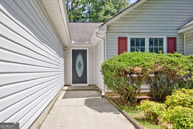 a front view of a house with garden
