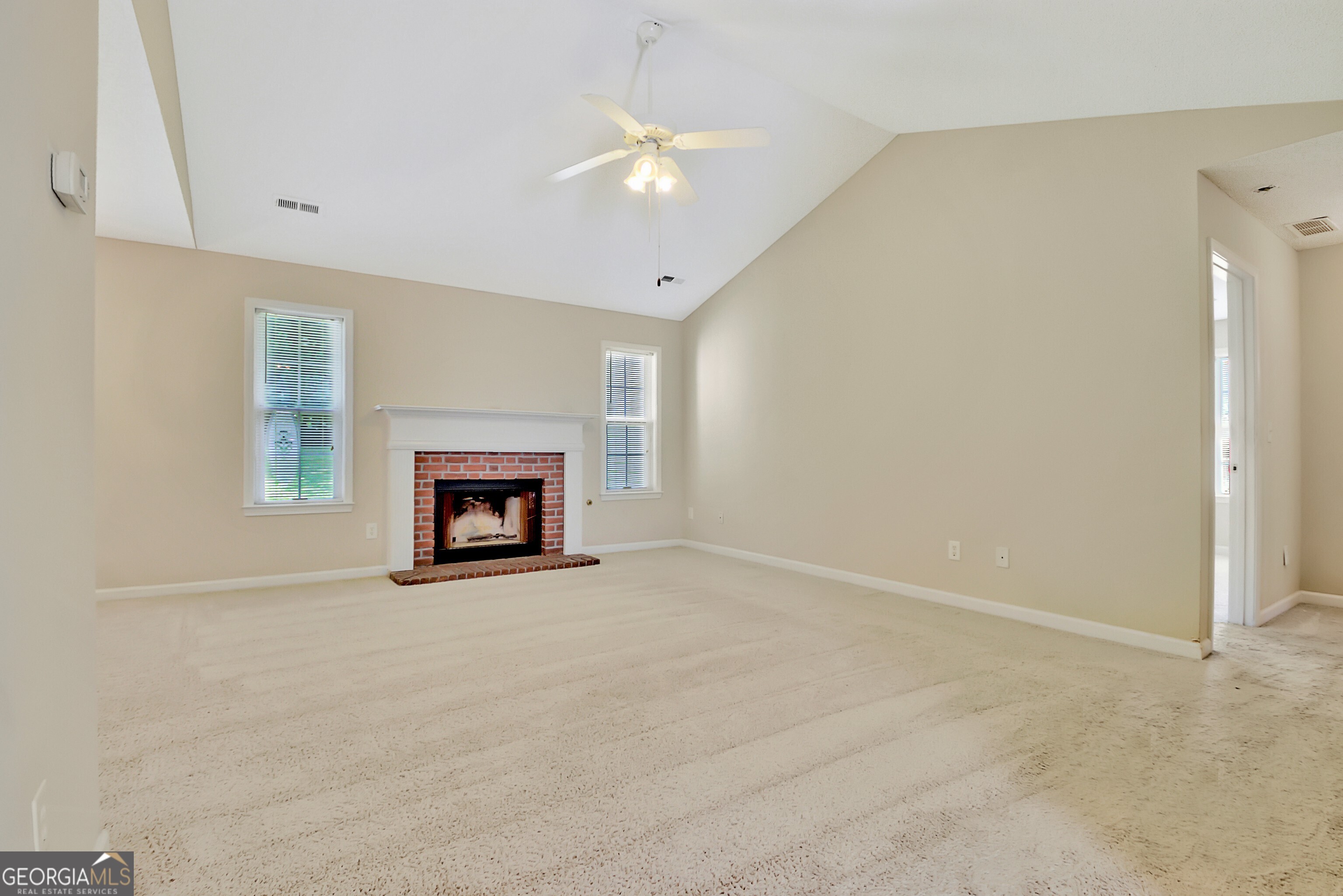 45 Paces Landing Drive Newnan, GA 30263 - Photo 7 of 31 an empty room with a fireplace and a window