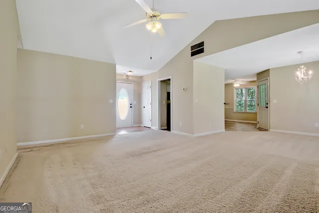 an empty room with a fireplace and fan