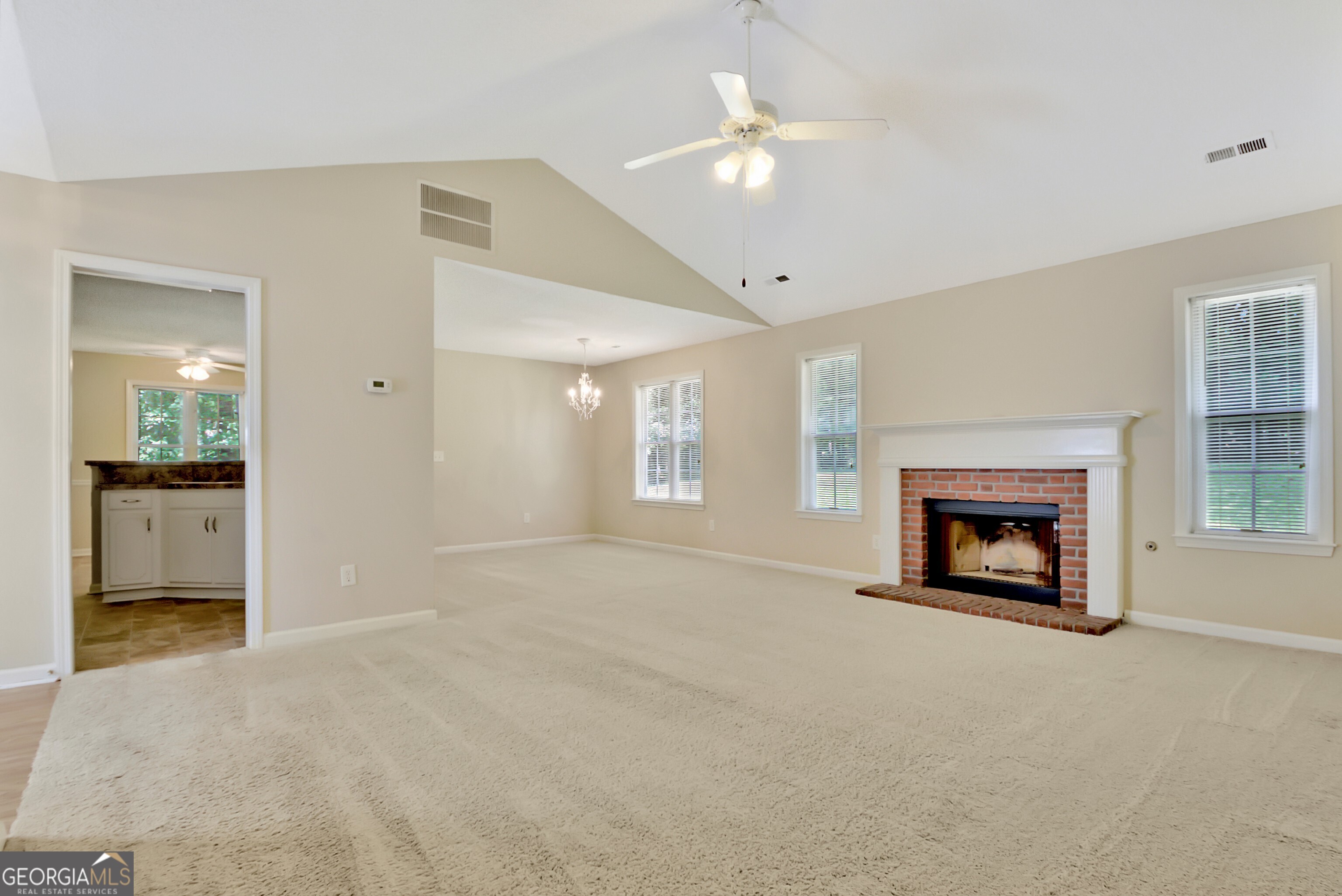 45 Paces Landing Drive Newnan, GA 30263 - Photo 9 of 31 an empty room with a fireplace and fan