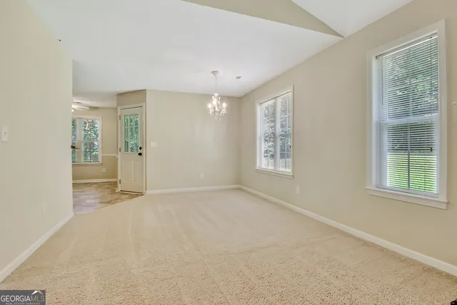 a view of a kitchen with a sink and a refrigerator