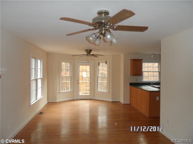 3769 Three Chopt Road Gum Spring, VA 23065 - Photo 3 of 10 a view of an empty room with window and wooden floor
